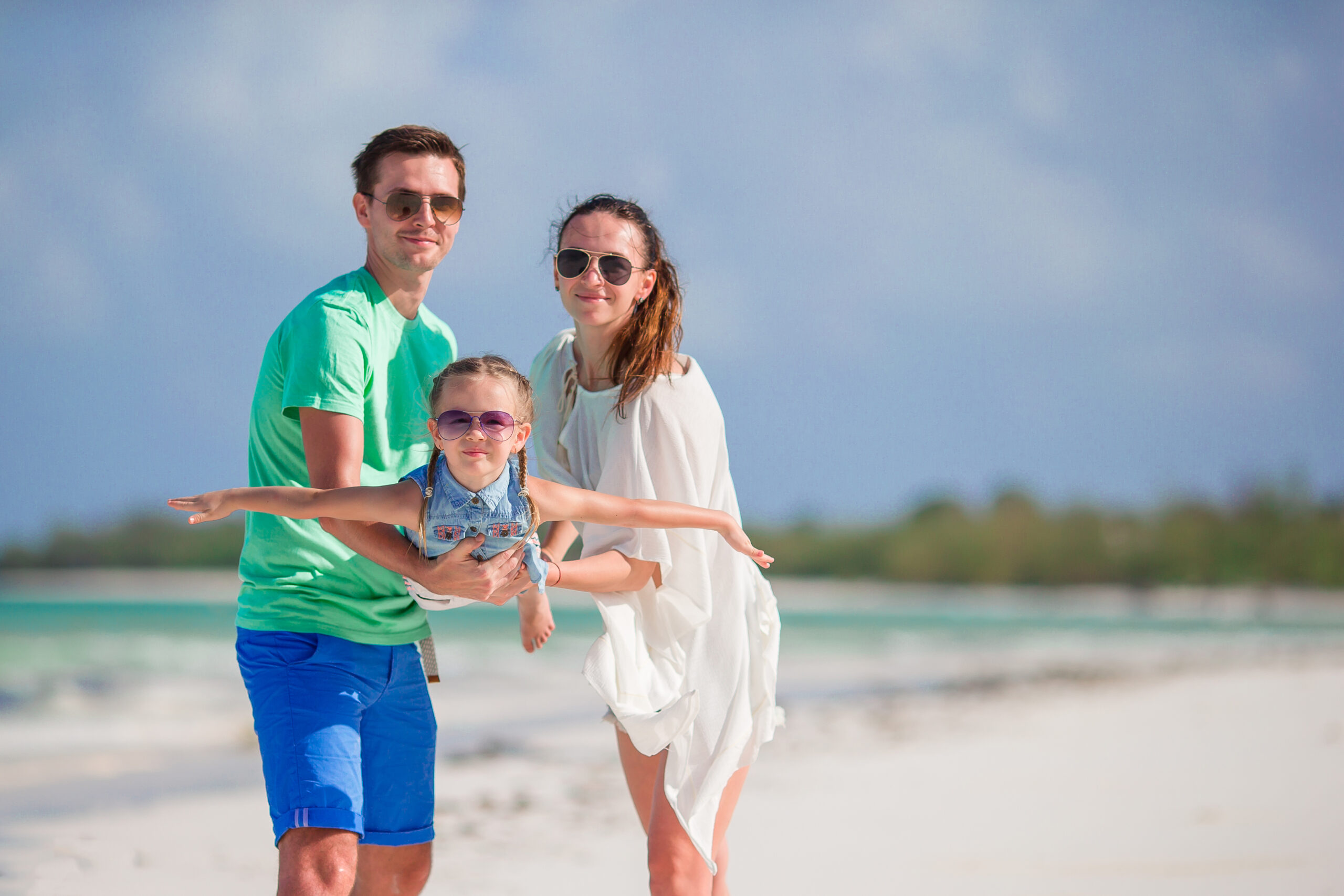 Happy beautiful family on a beach during summer vacation